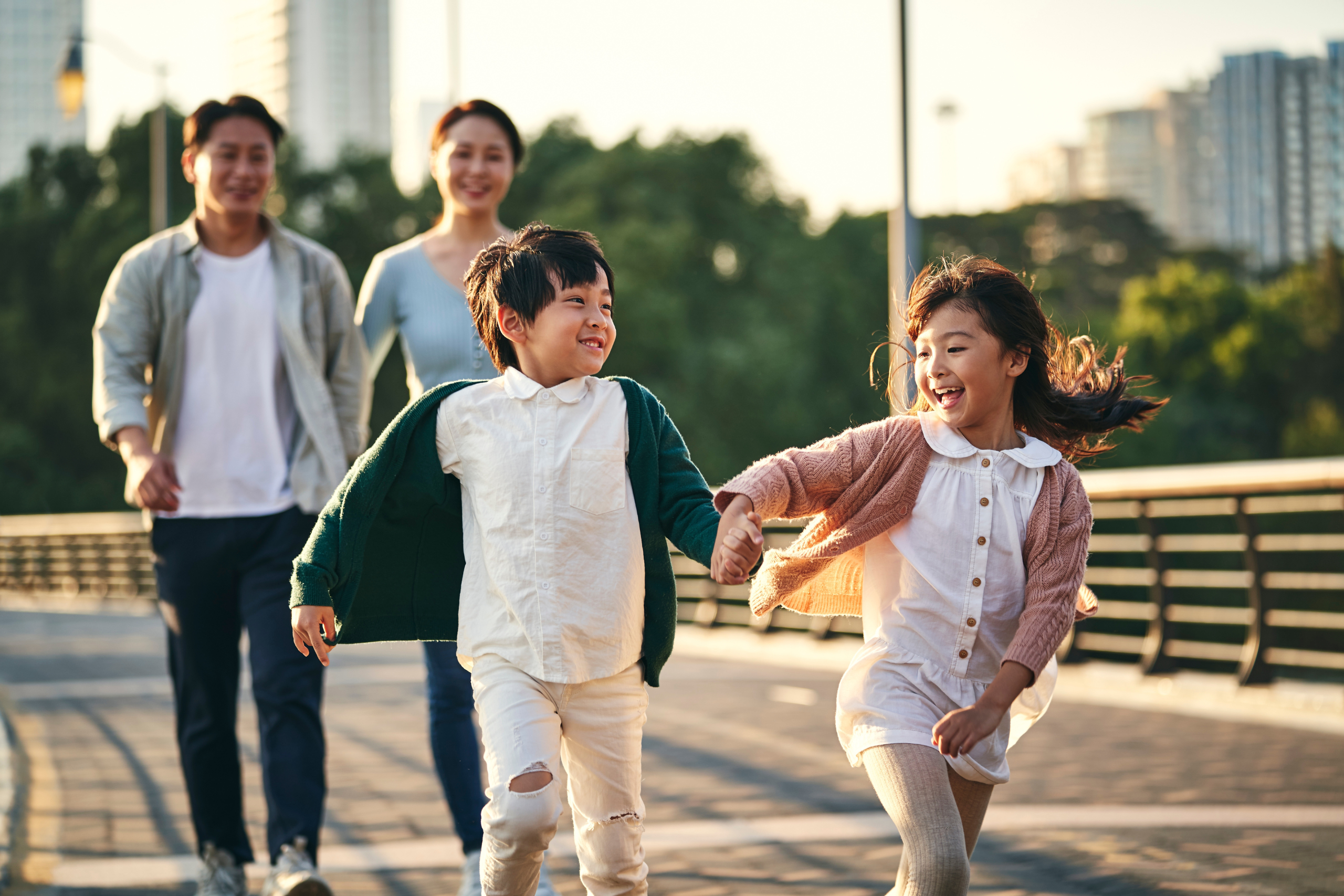 Asian family running with mom, dad, sister, brother